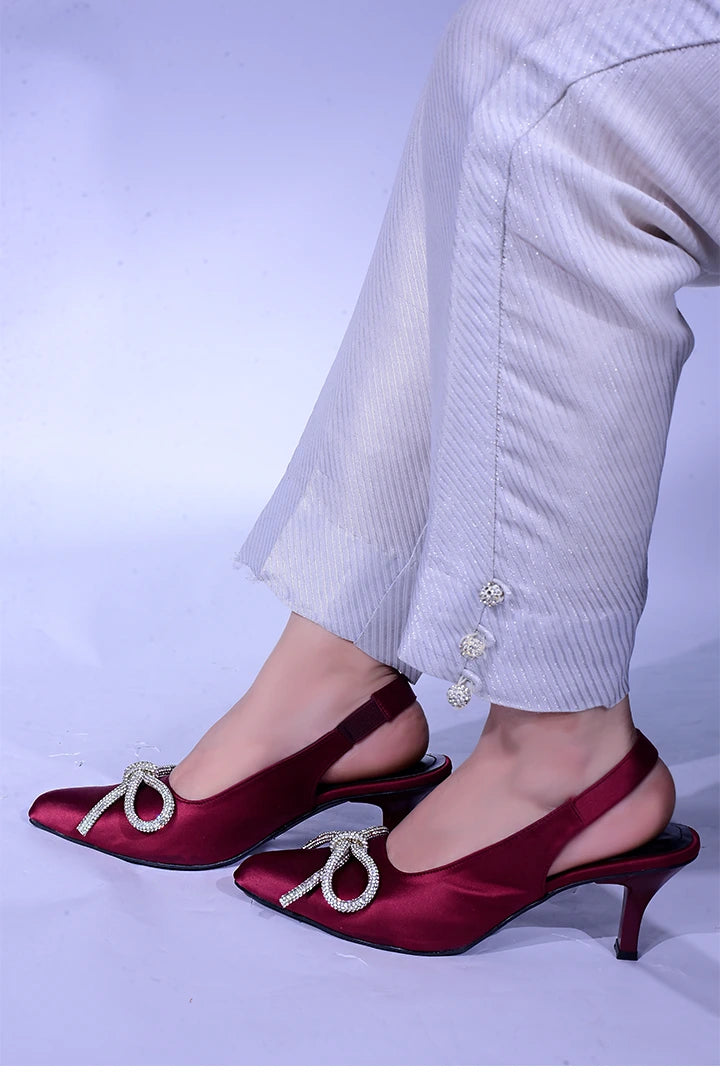 Maroon fancy heels with a shiny bow.